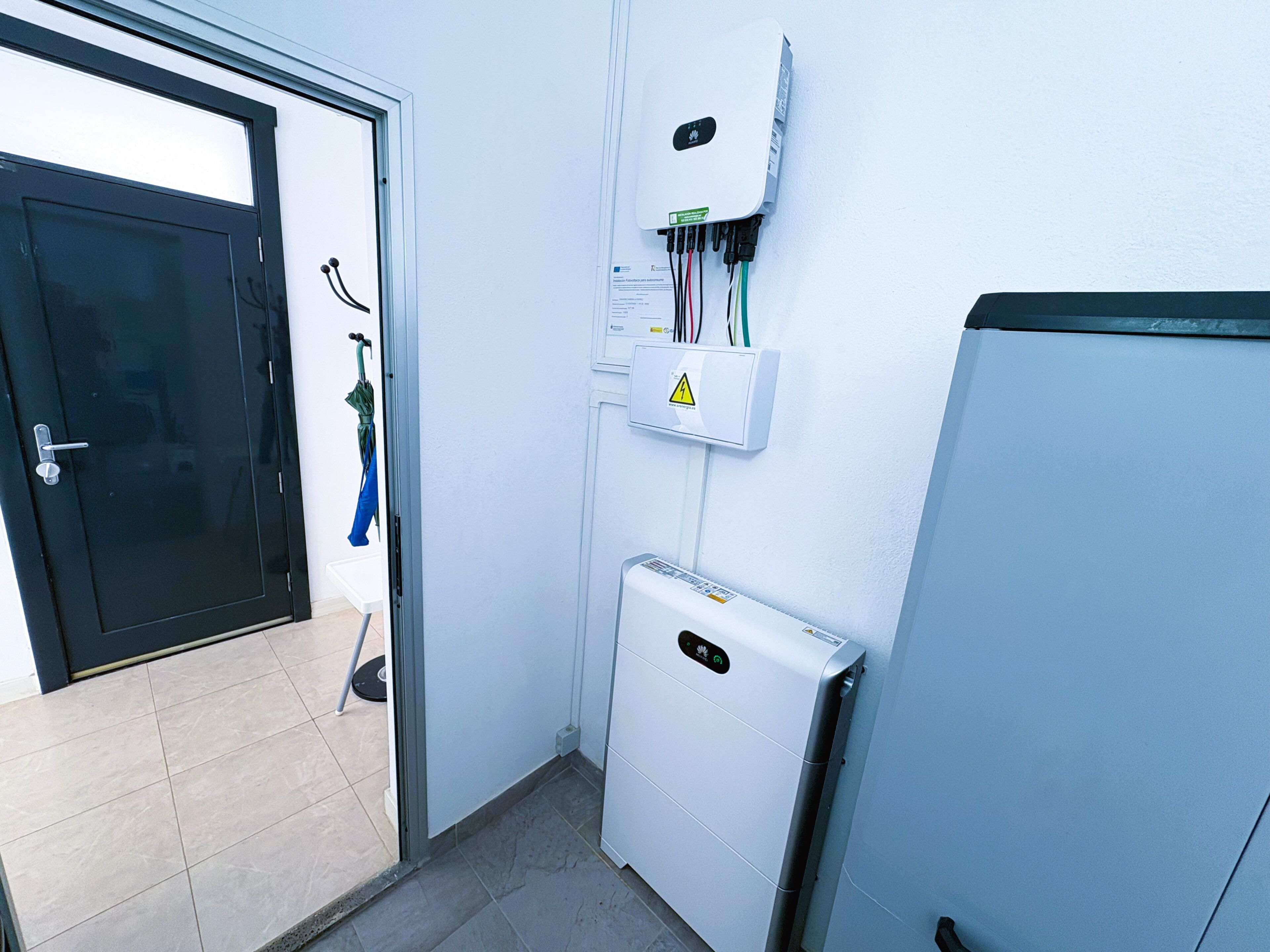 A bathroom with a toilet, a sink, and a shower area.