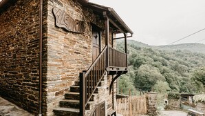A stone building with a wooden balcony and a sign that reads "LEDO".