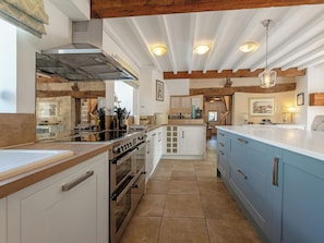 A kitchen with a central island, built-in oven, and wooden ceiling beams. - 7 bedroom accommodation in Bradbourne, near Ashbourne (Bradbourne, near Ashbourne)