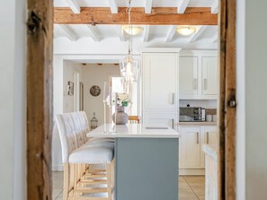 A modern kitchen with white cabinets, a central island, and a wooden ceiling. - 7 bedroom accommodation in Bradbourne, near Ashbourne (Bradbourne, near Ashbourne)