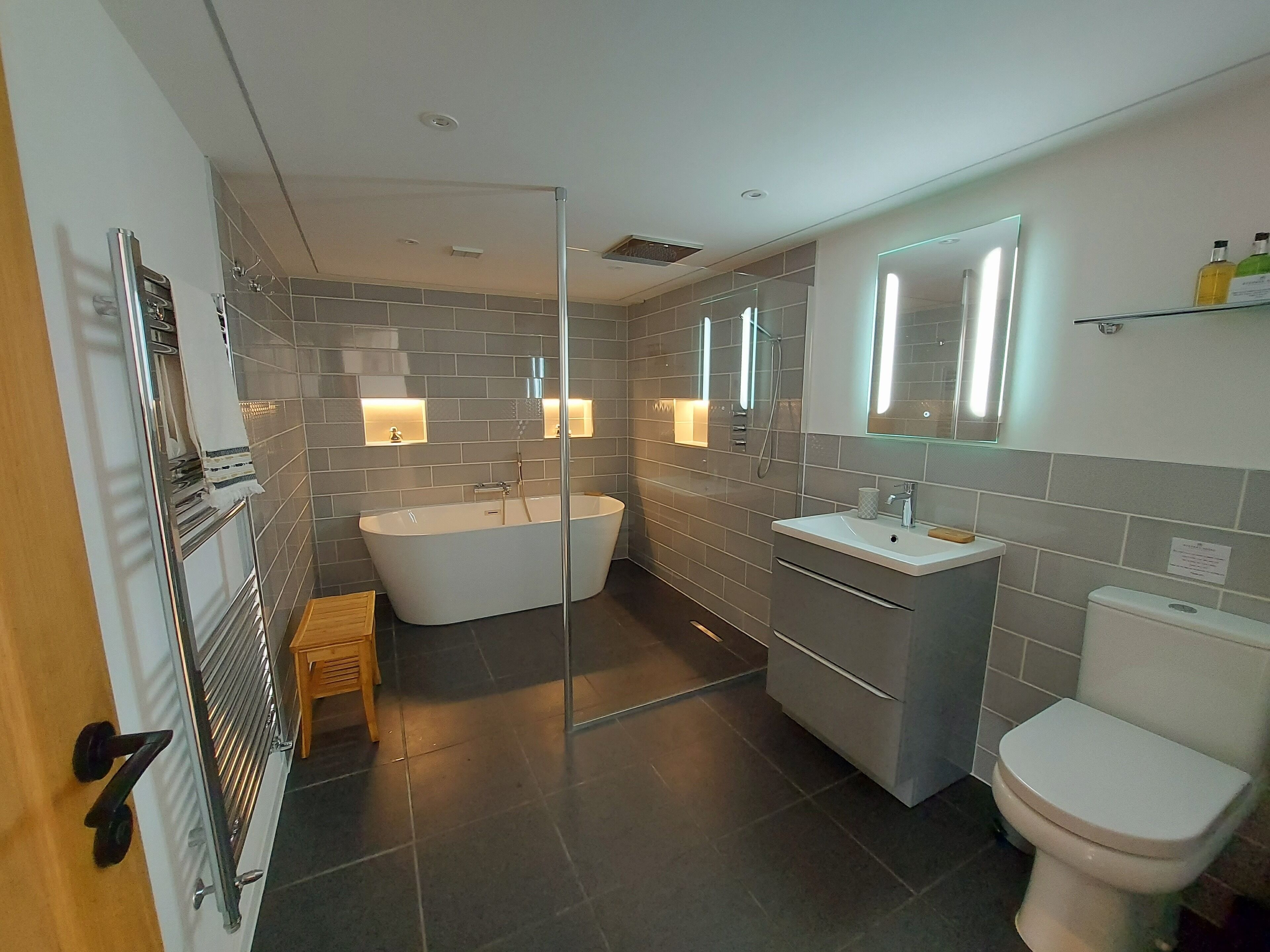 large bathroom with power shower and bath and underfloor heating
