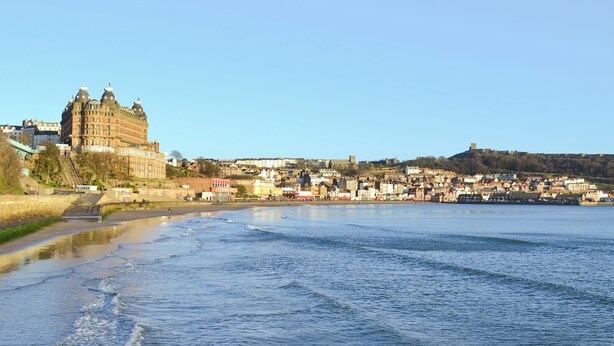 A waterfront cityscape with historic buildings and a castle-like structure. - 3 bedroom accommodation in Scarborough (Scarborough)