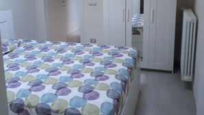 A bedroom with a bed, a wardrobe, and a radiator. - LITTLE FROG on UNESCO Piedmont Langhe Monferrato WINE HILLS. Garden BBQ pingpong (agliano terme)