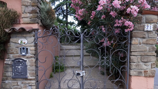 A wrought iron gate with a stone wall and a mailbox. - LITTLE FROG on UNESCO Piedmont Langhe Monferrato WINE HILLS. Garden BBQ pingpong (agliano terme)