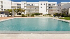 A modern hotel with a large pool, multiple balconies, and a clear blue sky. - 2 bedroom ground floor apartment, located on the award winning Lagos Marina   (Lagos)
