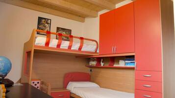 Cozy bedroom with a bunk bed and single bed, perfect for a comfortable stay.