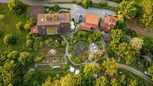 An aerial view of a residential area with multiple houses, a paved driveway, and surrounding greenery. - Dreamland—plenty of space for up to 5 guests (Überlingen, Baden-Württemberg, Germany)