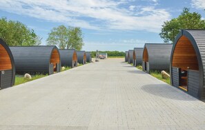 Accommodations line a scenic pathway, offering a glimpse into their cozy interiors.