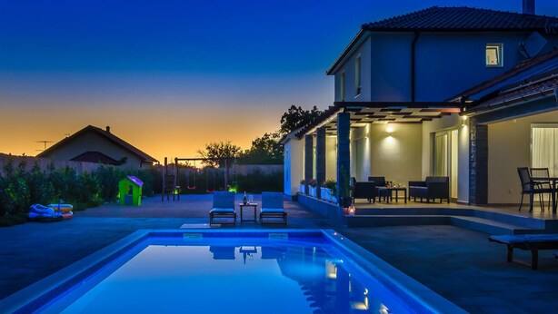 A modern house with a swimming pool, outdoor seating, and a patio area. - Gorgeous home in Sibenik (Sibenik)