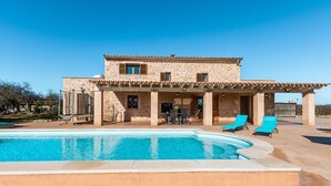 A two-story stone building with a swimming pool, outdoor seating, and a covered patio area. - Finca Capote, private pool, WIFI, A/C, 3 bedrooms, 2.5 bathrooms, 6 persons (Buger)