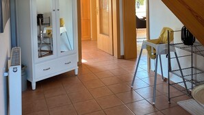 A spacious room with a large wardrobe, a staircase, and a chair. - Holiday house near Baltic Sea (Bay of Lübeck) (Ahrensbök)