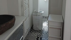 A bathroom with a patterned tile floor, a white radiator, a striped trash bin, and a white toilet. - Our islands : Ile du Pilier - 200m Beach (Saint-Jean-de-Monts)