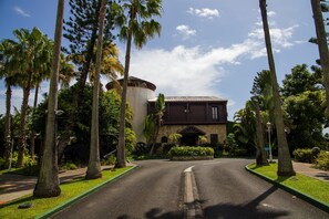 Stunning building with a traditional facade, set amidst lush greenery and manicured lawns.