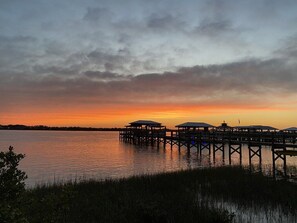 A pier extending into calm water with overhanging clouds during sunset. - Beach Retreat 4BR, Spa, Heated Pool, Screened Lanai (St. Augustine)
