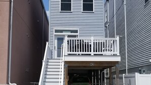A two-story house with a front porch and a garage. - Pet friendly- 1/2 block from beach Seaside Heights/Seaside park - ocean views.  (Seaside Heights)