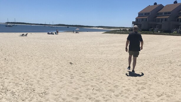 A sandy beach with a few people and boats in the distance. - Townhouse-Beach Vacation at the Yachtsman in Hyannis (Barnstable)