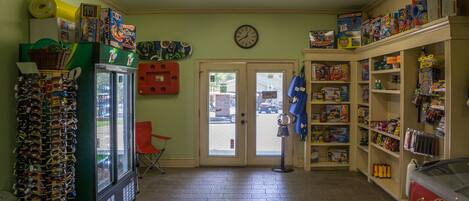 A small convenience store with a variety of products, including snacks, drinks, and sunglasses.