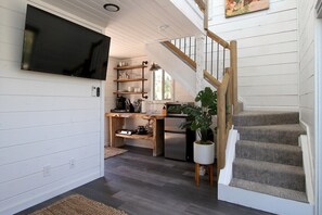 Enjoy cooking in this well-equipped kitchen with a TV and convenient access to the upper level.