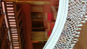 A multi-level wooden structure with a white netted canopy. - Casa Pitaya chalet house (Delicias de Cobano)