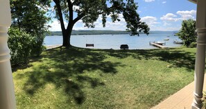 Relax by the serene lake with a peaceful view, a shaded swing, and a dock for boating.