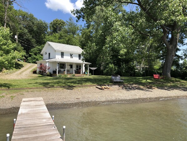 Escape to a serene lakeside retreat with a covered porch and tranquil views.