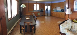 Enjoy meals in the kitchen with a refrigerator, microwave, and sink, and dine at the table with chairs and a bench.