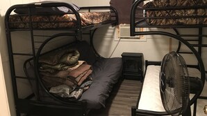 A bunk bed room with a fan and a heater.