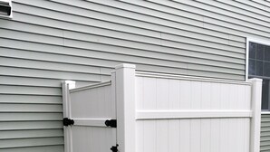 A white outdoor storage bench with a metal frame, positioned against a house with horizontal siding. - Beautiful, recently built 6BR/ 4BA Home in Narragansett Pier!!! (Narragansett)