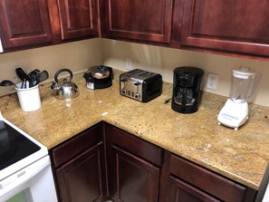 Microwave, dishwasher, coffee/tea maker, cookware/dishes/utensils
