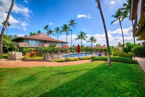 A hotel with a swimming pool, palm trees, and a well-maintained lawn. - Last Min Cancel. Save. Must See 1 BR Kaanapali, Beach Cabana, Jacuzzi (Kaanapali)