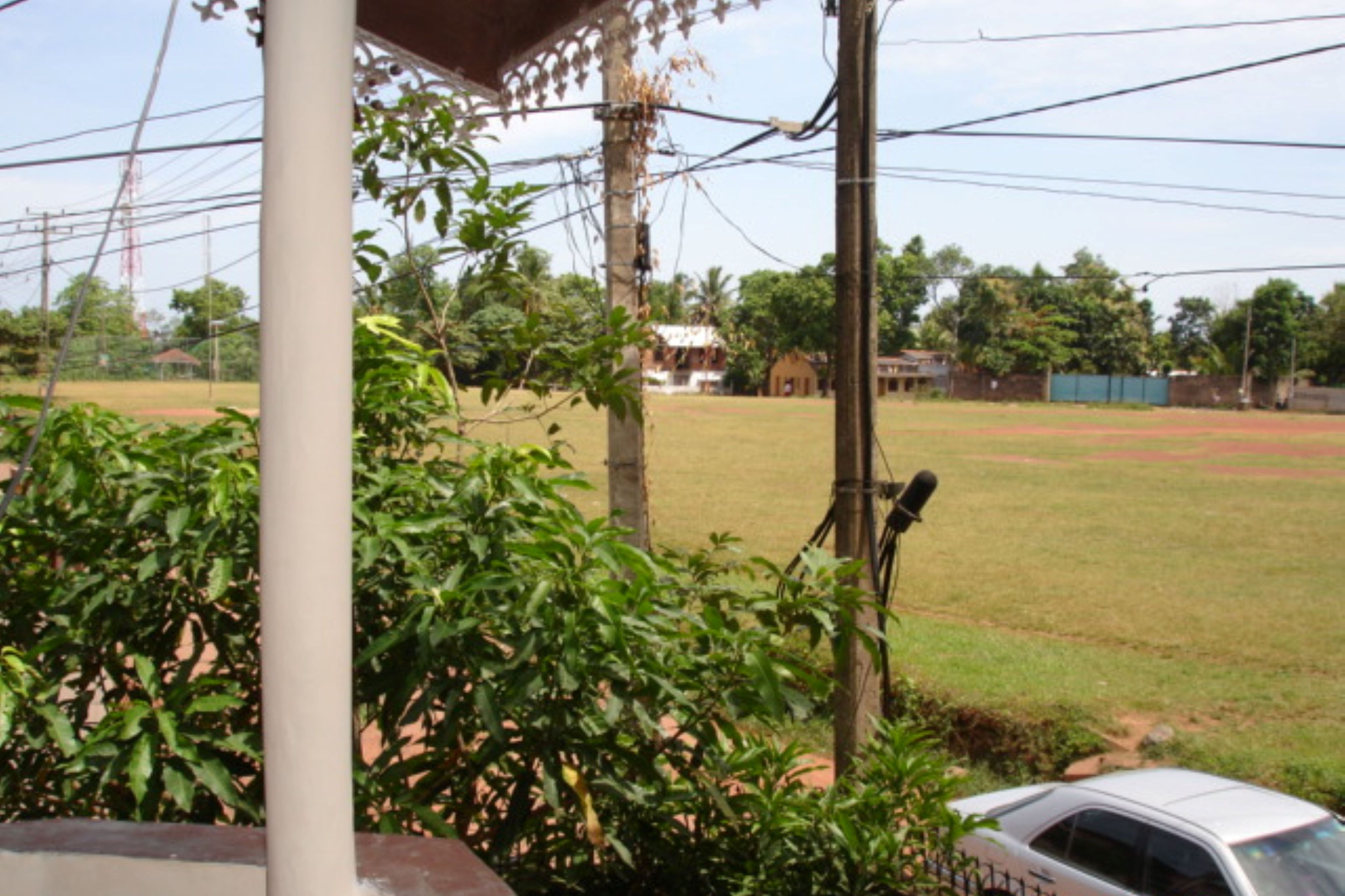 A sports field with a car parked nearby.