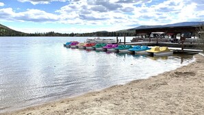 A lakeside dock with colorful paddle boats and a wooden pier. - Lakeside Mountain Retreat with HOT TUB! (Grand Lake)