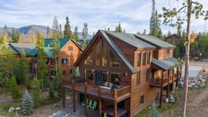 A wooden cabin with a balcony, surrounded by trees and mountains. - Lakeside Mountain Retreat with HOT TUB! (Grand Lake)