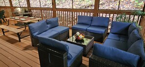 Guests can enjoy the deck's comfortable seating and dining area.