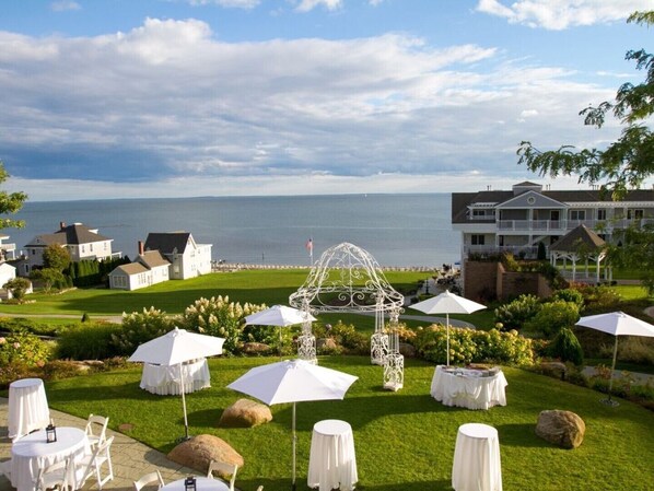 A coastal resort with outdoor seating, a gazebo, and a view of the sea.