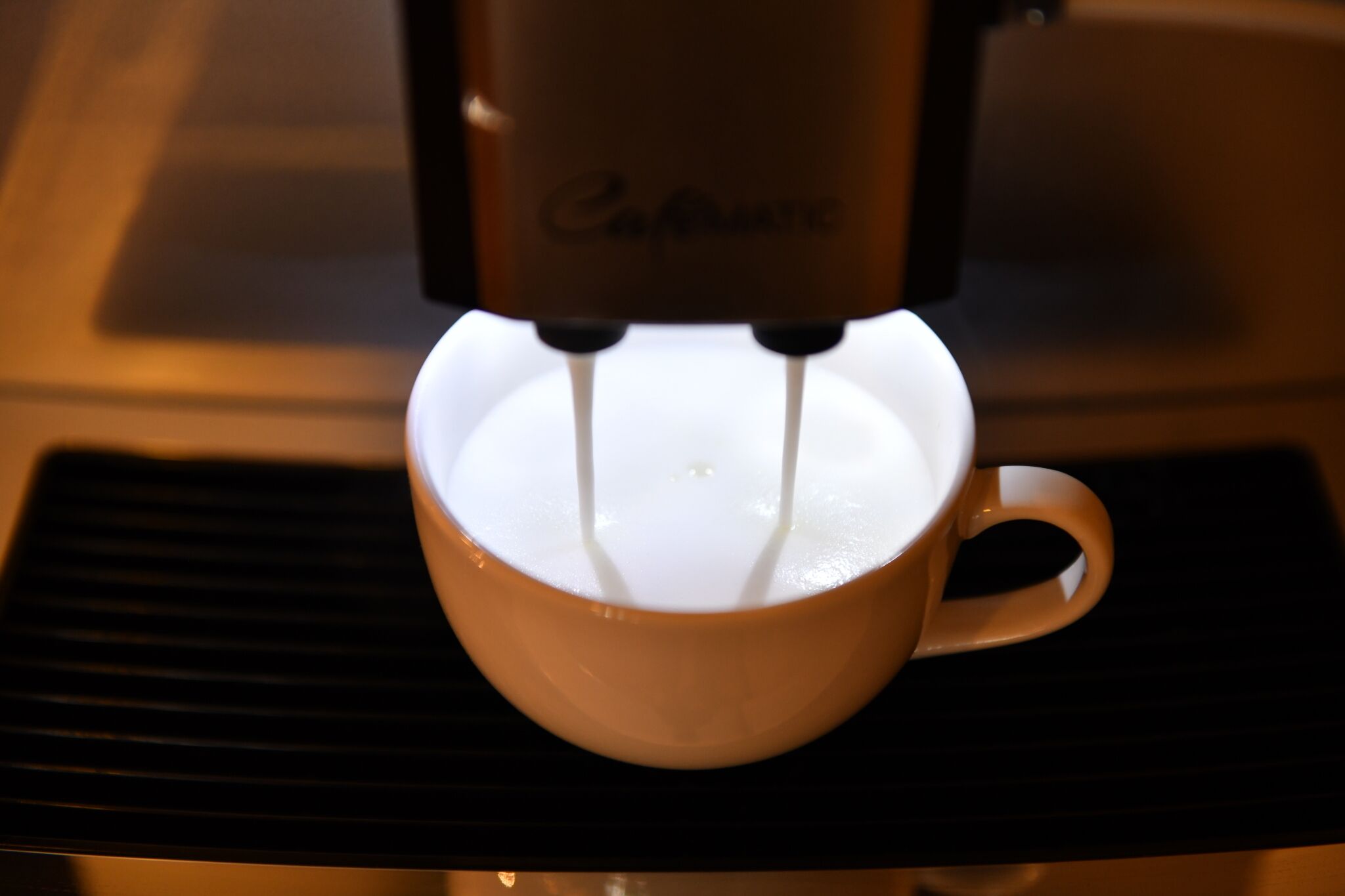 A coffee machine dispensing coffee into a cup.
