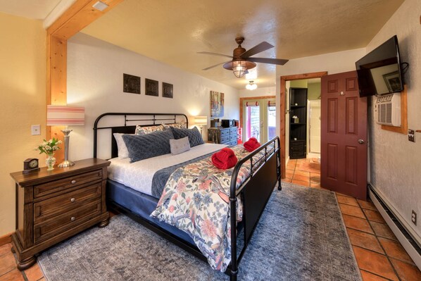 A bedroom with a bed, nightstand, dresser, and a ceiling fan. - The Willow Cottage (Cali Cochitta ) (Moab)