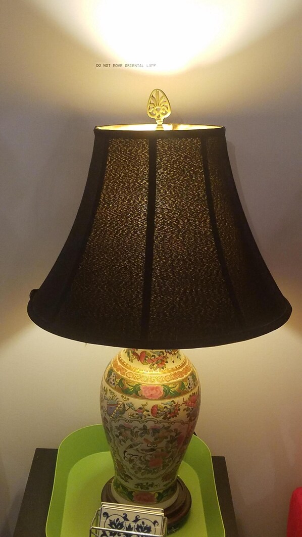 A table lamp with a decorative base and a black lampshade.