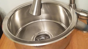 A stainless steel sink with a curved faucet on a wooden countertop. - Tinyhouse, Enchanted Cottage nestled in the backyard of the fenced in property. (Atlanta)