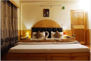 Relax in comfort with a large bed, bedside tables, and a stylish wardrobe.