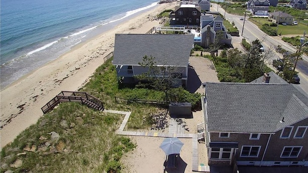 A coastal residential area with houses, a beach, and a clear view of the ocean. - Quintessential New England Home on Private Beach  (Westerly)