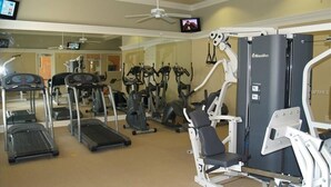 A gym with treadmills, elliptical machines, and weight machines.