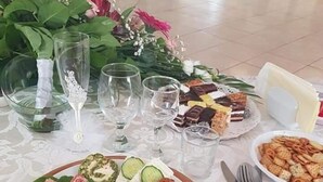 A table set with various food items, glasses, and cutlery, suggesting a dining setup. - Hotel Etrusco (Gherla)