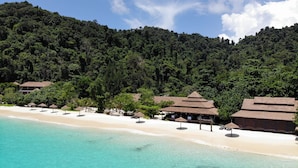 A beach resort with a clear turquoise sea, a sandy shore, and a backdrop of dense forest. - Victoria Cliff Nyaung Oo Phee Island (Kawthaung)