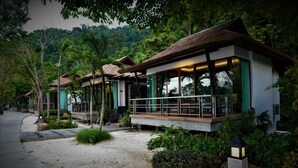 A resort with modern architecture, featuring a pathway leading to a building with a balcony and large windows. - Victoria Cliff Nyaung Oo Phee Island (Kawthaung)