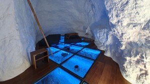 An ice hotel interior with a wooden floor, glass panels, and a wooden ladder. - Redondo de Guayedra (Agaete)