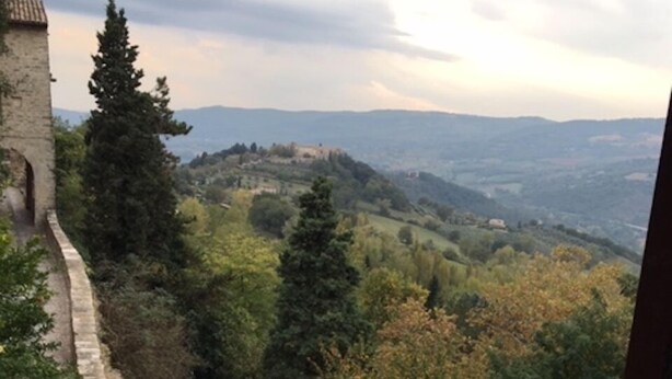 A stone pathway leading to a hilltop with a view of distant hills and trees. - Spectacular Views  -  Charming House in Central Todi  (Todi)