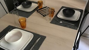 A dining table set with plates, bowls, glasses, and cutlery. - The Vieux Fossés duplex (Romorantin-Lanthenay)