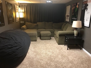 Relax in comfort with a large bed, a cozy sofa, and a projector for movie nights.