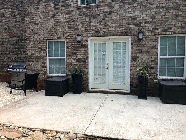 Enjoy al fresco dining on the patio, equipped with a grill and comfortable seating for two.
